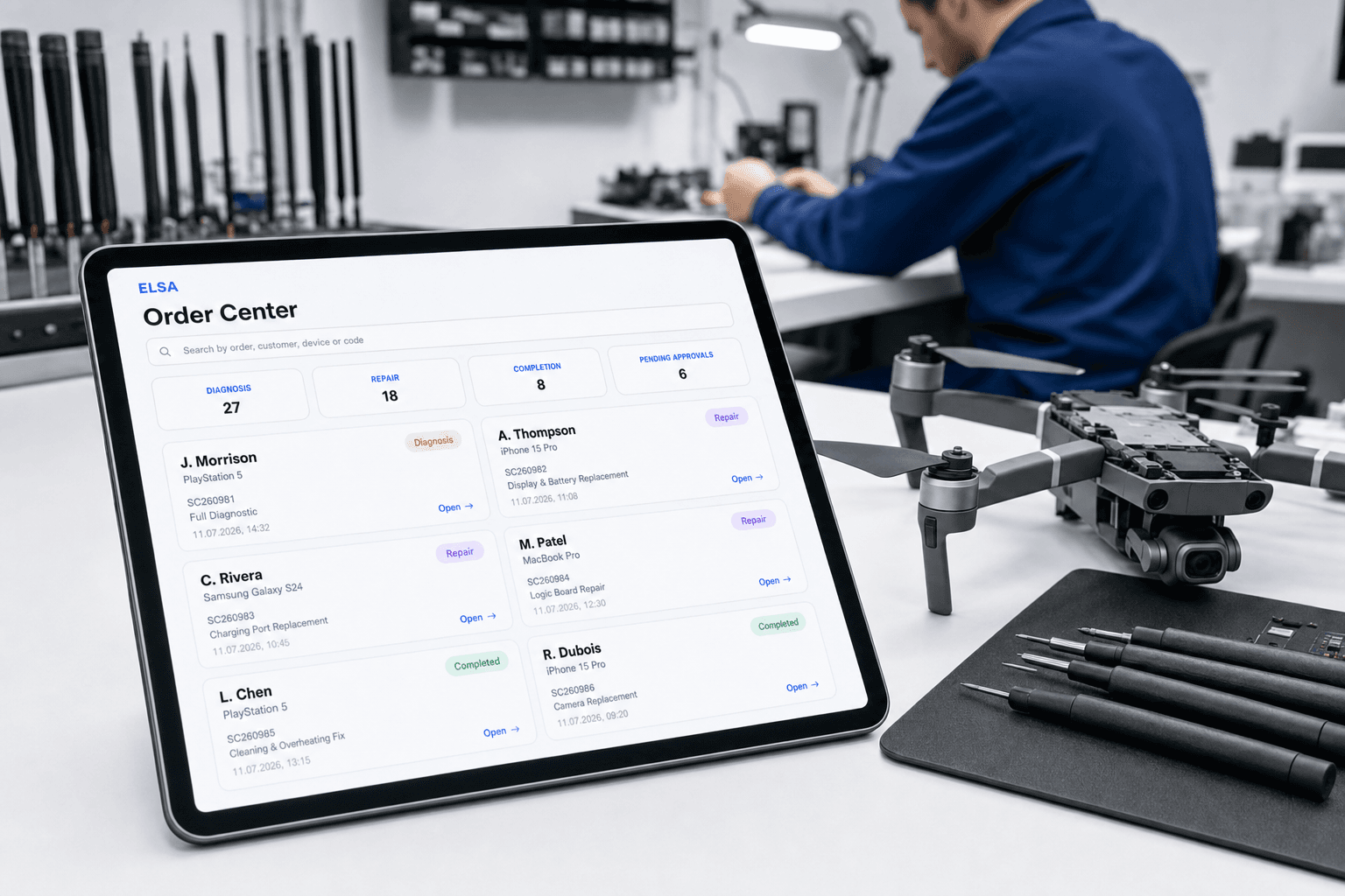 Technician in a repair workshop using ELSA on a tablet
